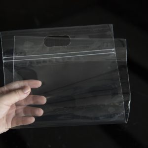 The zipper plastic bag is picked up to show transparency on a black background.